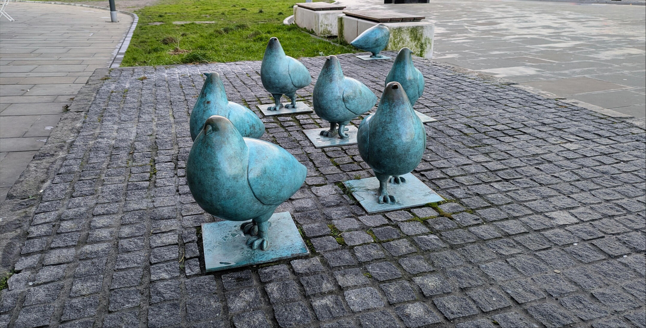 A group of comically proportioned pigeon statues on Edinburgh's Elm Row. The pigeons are very orbular and officious looking, with a lifelike impression of strutting motion. The statues are designed by Shona Kinloch, photo taken by C. K. Pidgeon